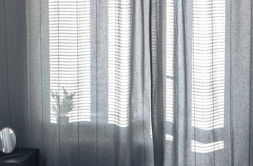 Room interior with curtains and blinds in sunny weather, shine the shadows.